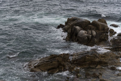 High angle view of rock formation in sea