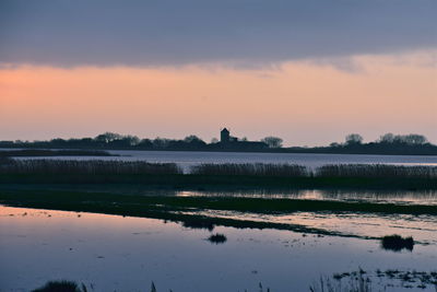 Scenic view of lake against sky during sunset