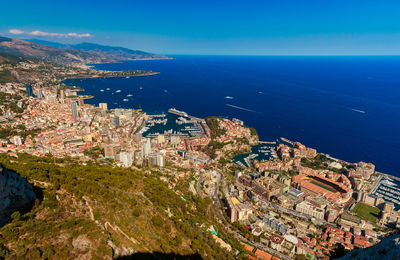 High angle view of city by sea against sky