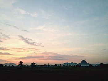 Scenic view of landscape against sky at sunset