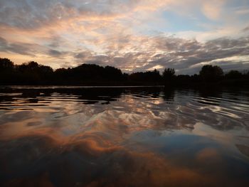 Scenic view of calm lake at sunset