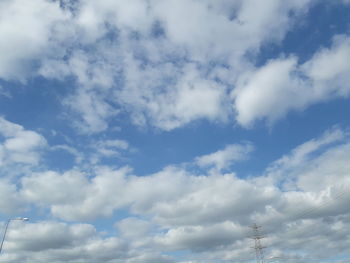 Low angle view of telephone pole against sky