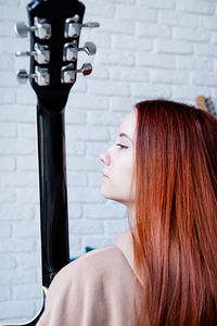 Side view of young woman looking away