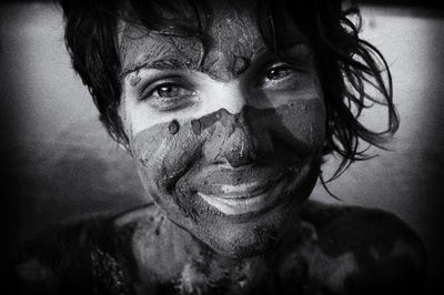 Close-up portrait of smiling woman wearing mask