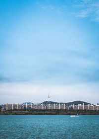 View of city buildings against cloudy sky