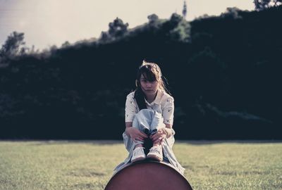 Woman standing on grassy field