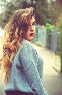 Portrait of woman standing at park