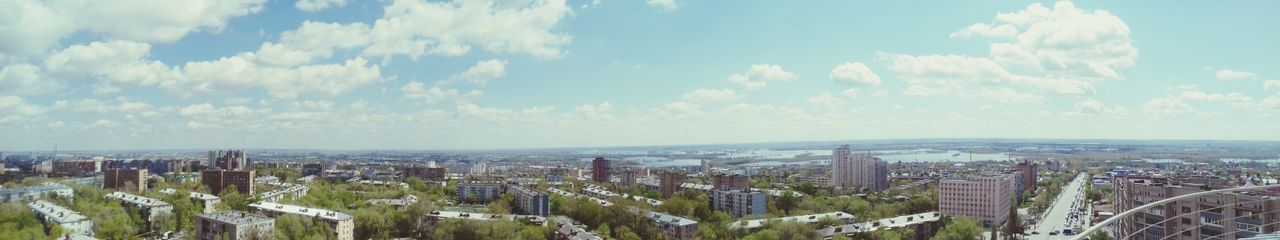 Panoramic view of cityscape against cloudy sky