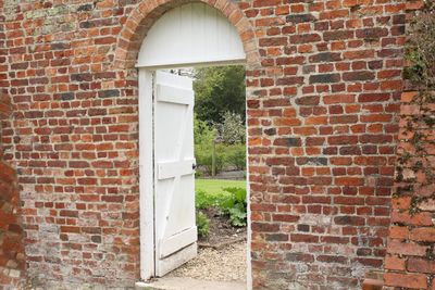 Open door of brick wall