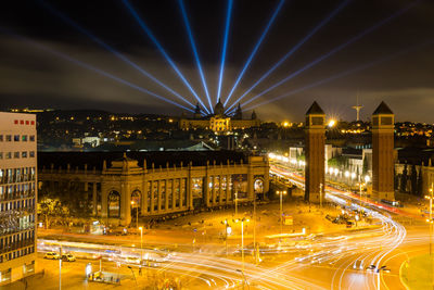 Illuminated city against sky at night