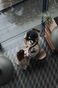High angle view of woman sitting on floor