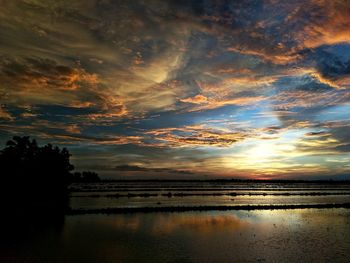 Scenic view of lake against romantic sky at sunset