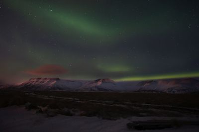 Scenic view of landscape against sky at night