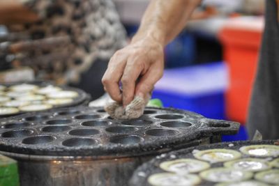 Midsection of man preparing food