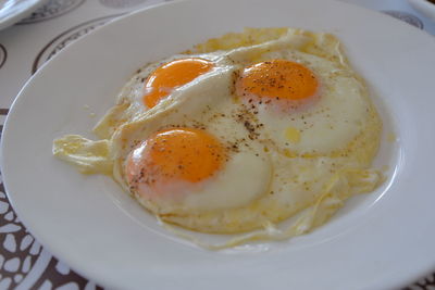 Fried eggs in plate on table