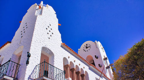 Low angle view of buildings against blue sky