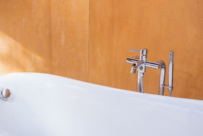 Close-up of faucet in bathroom