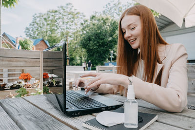 Working safely in new normal. how to make a covid secure workplace. redhead business woman 