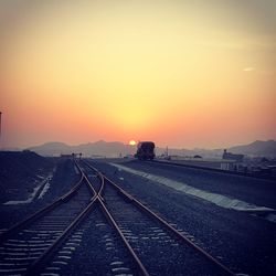 View of railroad tracks against sky during sunset