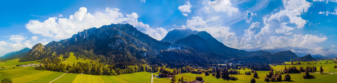 Panoramic aerial view of neuschwanstein castle and surrounding alp mountains