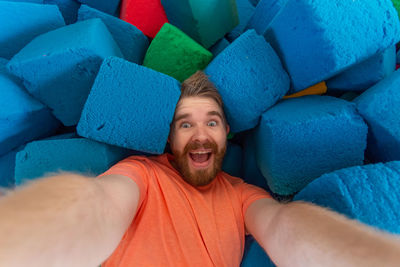 Portrait of smiling man lying down on sofa