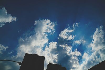 Low angle view of buildings against blue sky