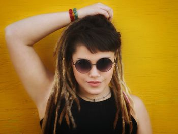 Close-up portrait of beautiful young woman with dreadlocks
