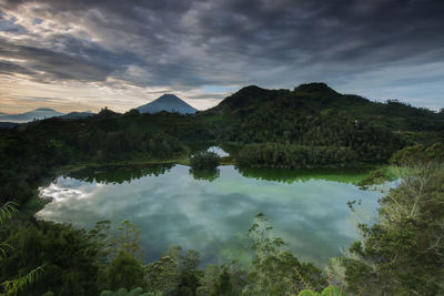 Scenic view of lake and mountains against sky