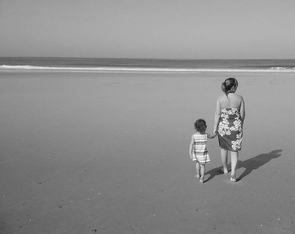 FULL LENGTH OF FATHER WITH DAUGHTER ON BEACH