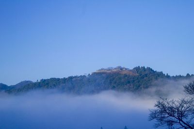 Scenic view of mountains against clear blue sky