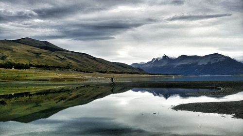 Scenic view of lake and mountains against sky