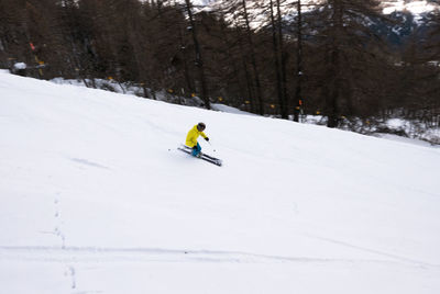 Man skiing on snow covered land