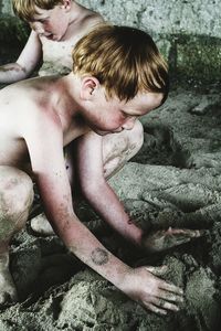 Two boys playing in sand