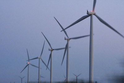 Low angle view of wind turbine against sky