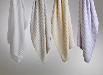 Close-up of towels hanging against white background
