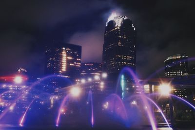 Illuminated city against sky at night