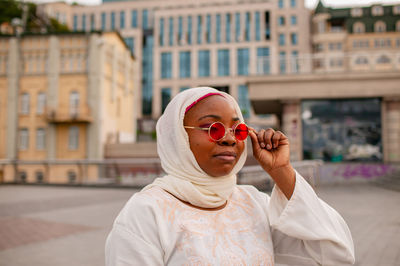 Portrait of young woman in city