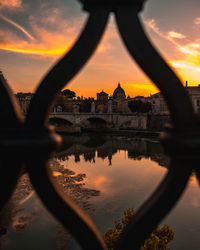 Reflection of buildings in city during sunset