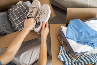 Low section of woman lying on bed at home