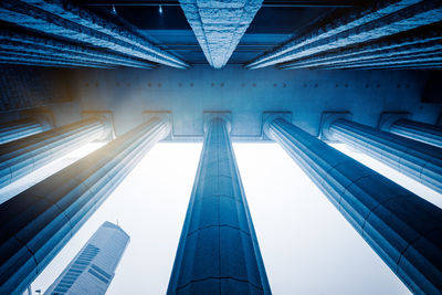 Low angle view of modern buildings against blue sky