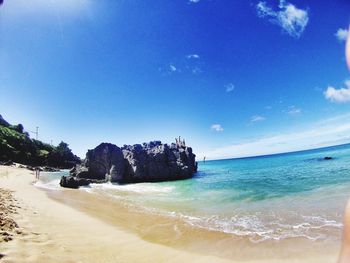 Scenic view of sea against blue sky