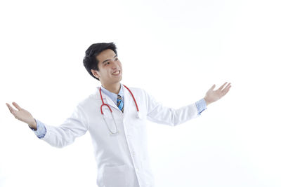 Young man standing against white background