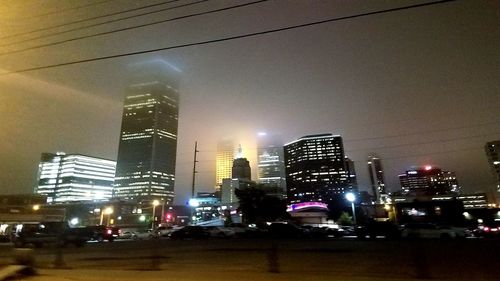 Low angle view of city lit up at night