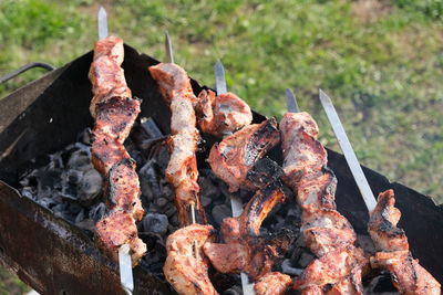 High angle view of meat on barbecue grill