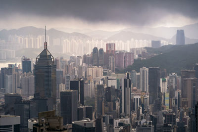 Aerial view of buildings in city against sky