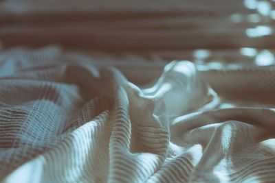 Low section of person relaxing on bed at home