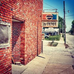 Road sign against brick wall