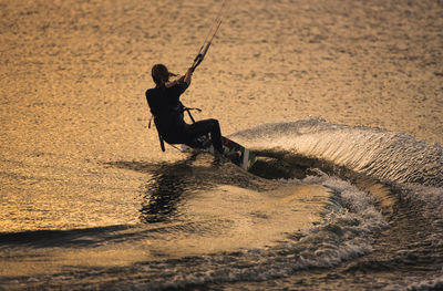 Man surfing on sea shore