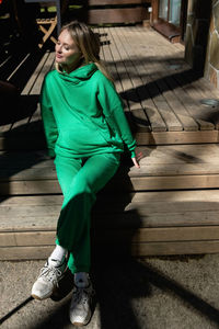 Portrait of young woman walking on footpath