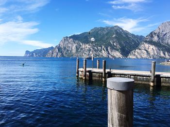 Pier on lake with mountain range in background